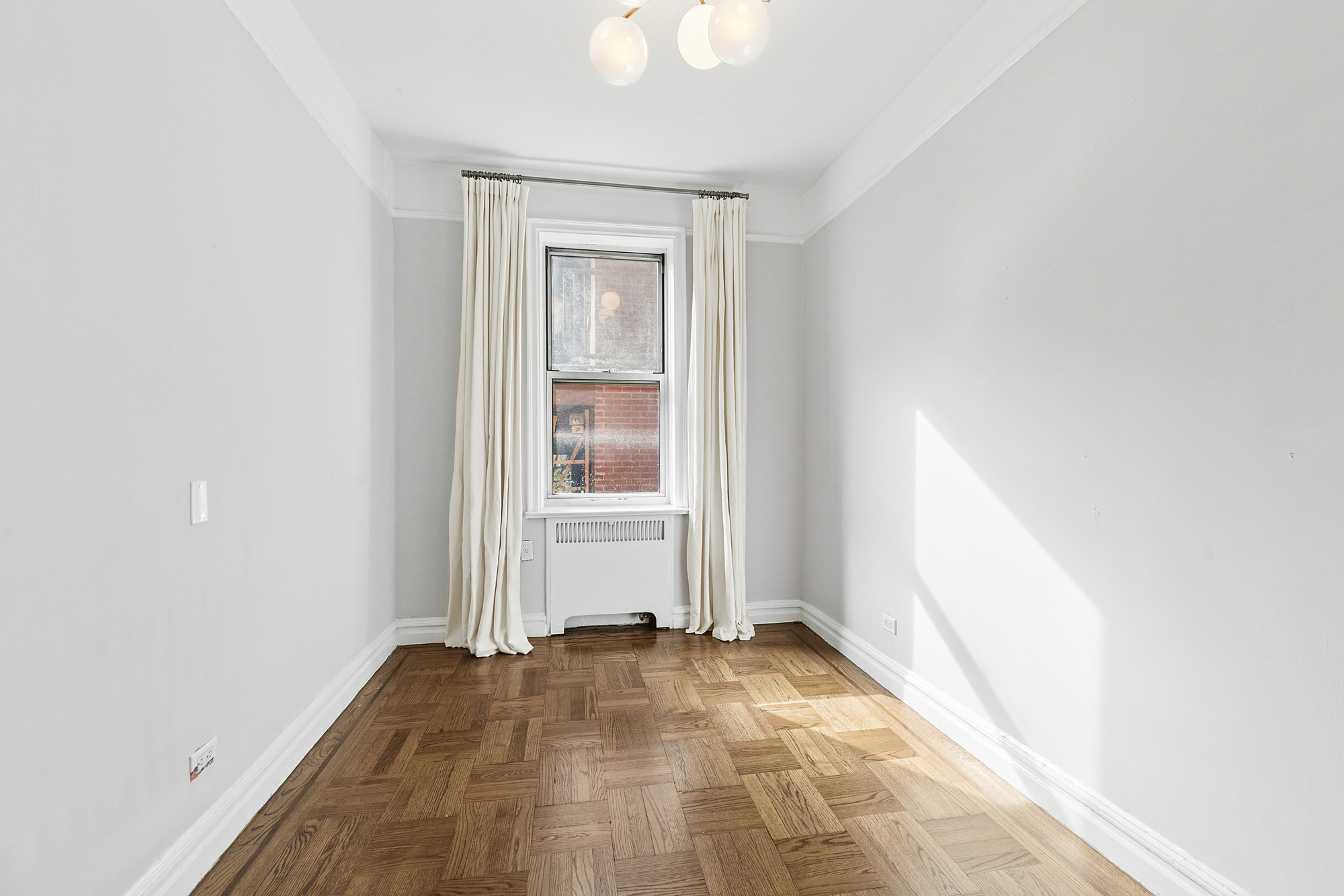 680 West 204th Street, Unit 3E Manhattan, NY 10034 - Photo 6 of 7 a view of empty room with wooden floor