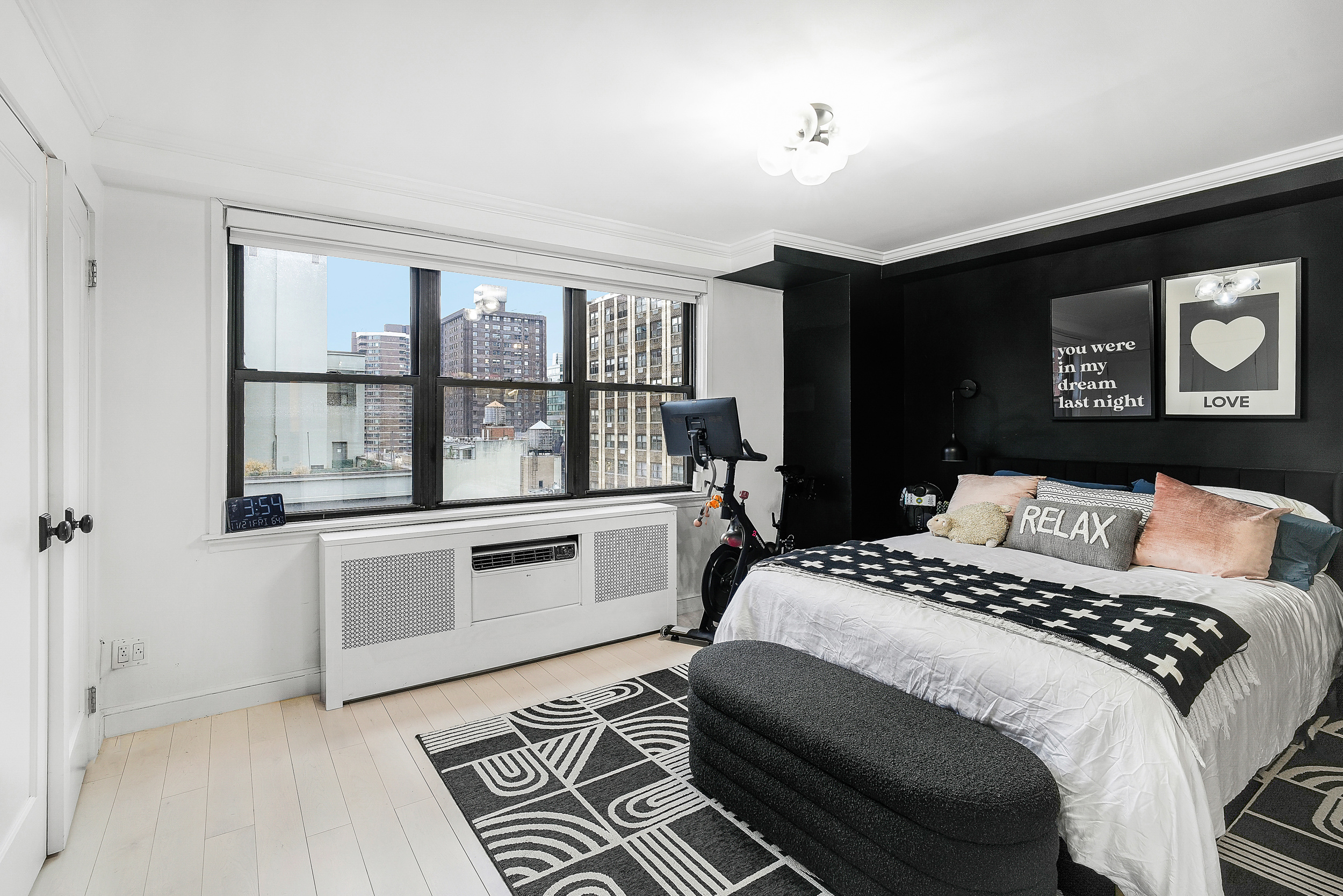 330 3rd Avenue, Unit 15G Manhattan, NY 10010 - Photo 8 of 14 a bedroom with a bed and glass windows