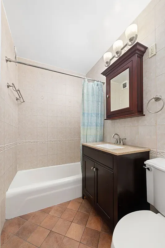 a bathroom with a sink mirror vanity and toilet