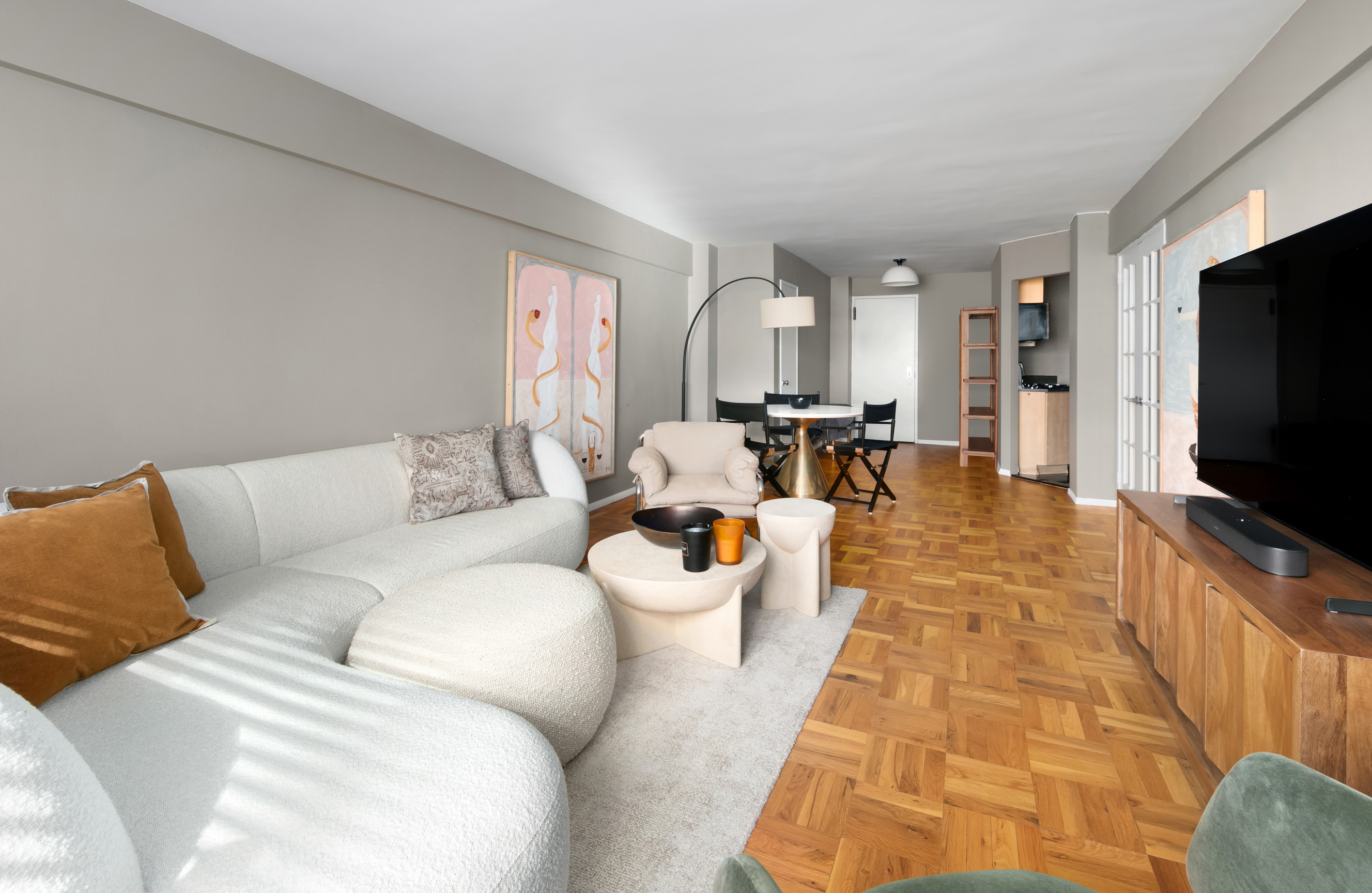 420 East 64th Street, Unit E3A Manhattan, NY 10065 - Photo 2 of 8 a living room with furniture and a flat screen tv