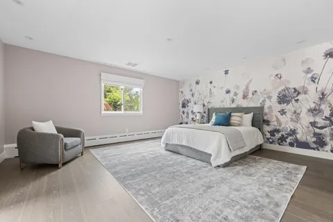a bedroom with a bed and a chair