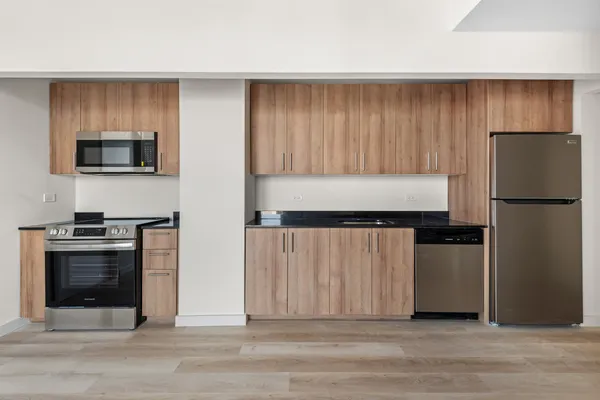 a kitchen with a refrigerator stove and microwave