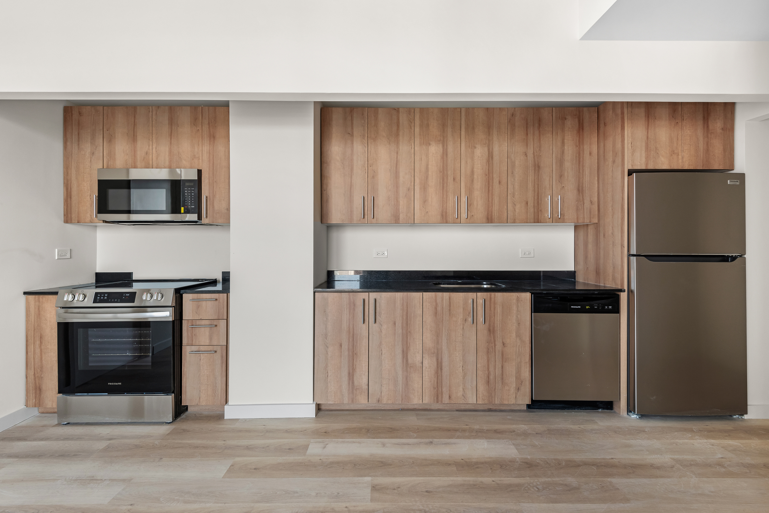 1333 Broadway, Unit 1104 Brooklyn, NY 11221 - Photo 3 of 14 a kitchen with a refrigerator stove and microwave