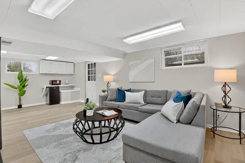 a living room with furniture and kitchen view