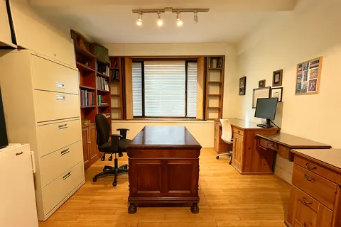 a living room with a table chairs and a kitchen view