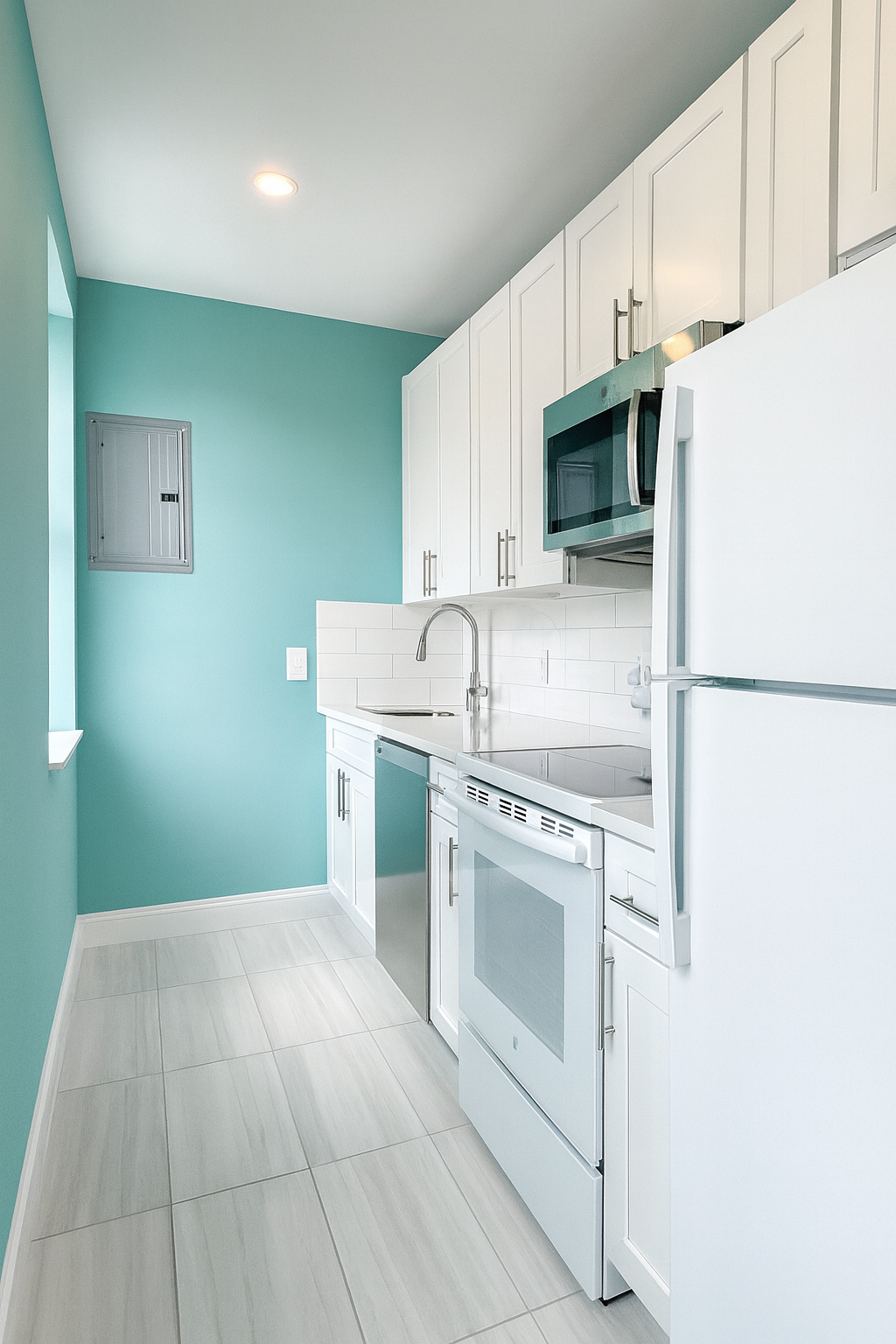 212 Front Street, Unit 4 Manhattan, NY 10038 - Photo 6 of 7 a kitchen with granite countertop a sink stove and refrigerator
