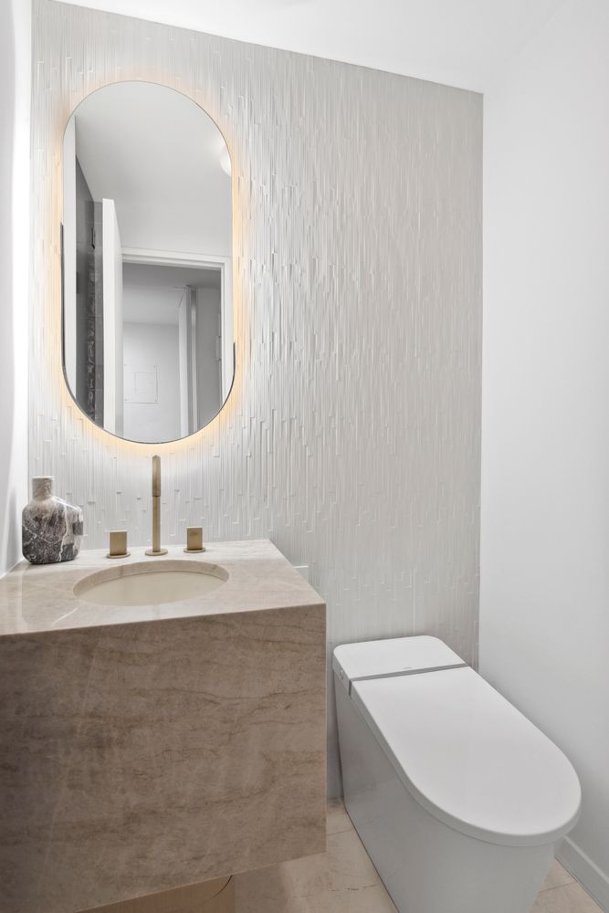 650 Park Avenue, Unit 9B Manhattan, NY 10065 - Photo 11 of 14 a bathroom with a toilet a sink and mirror