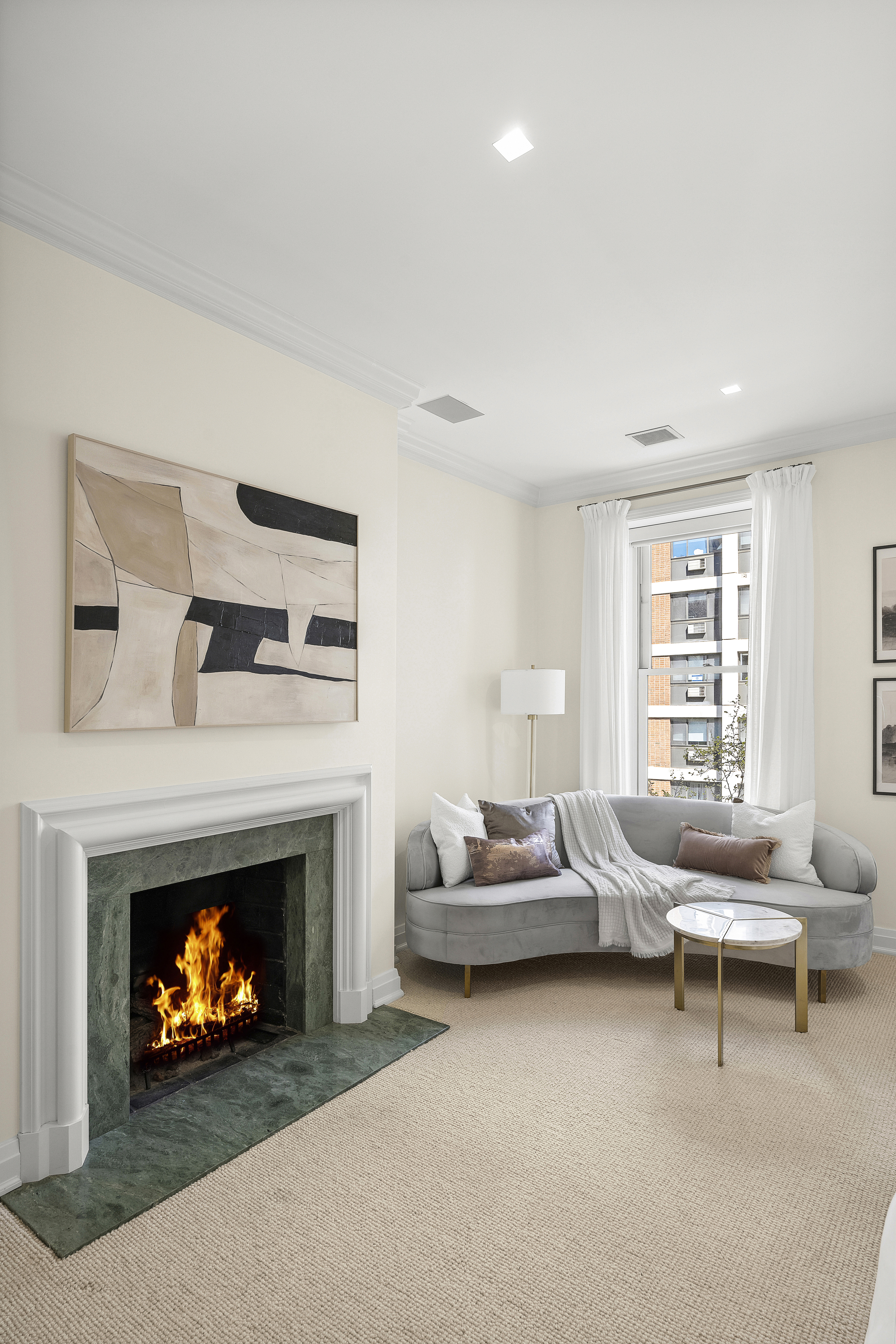 50 East 73rd Street Manhattan, NY 10021 - Photo 7 of 32 a living room with furniture a fireplace and a window