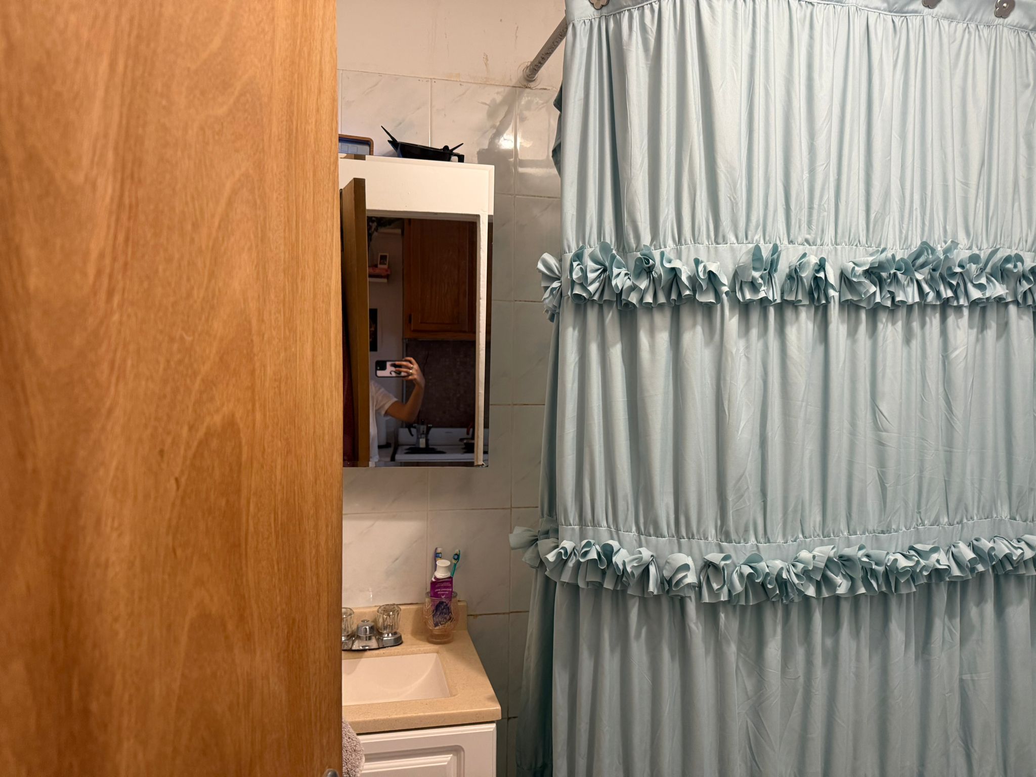 1278 1st Avenue, Unit 2 Manhattan, NY 10065 - Photo 19 of 19 a bathroom with a shower curtain and a window