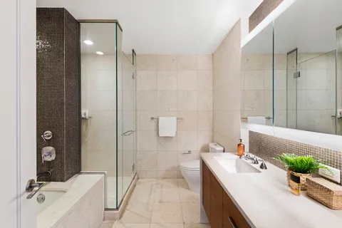 a bathroom with a tub sink and mirror