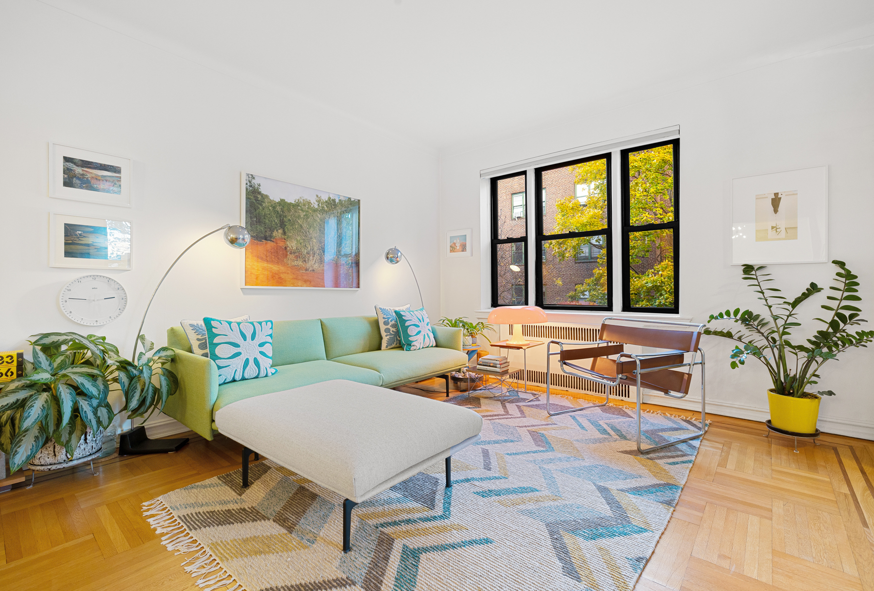 77-11 35th Avenue, Unit 3N Queens, NY 11372 - Photo 3 of 21 a living room with furniture large window and potted plants