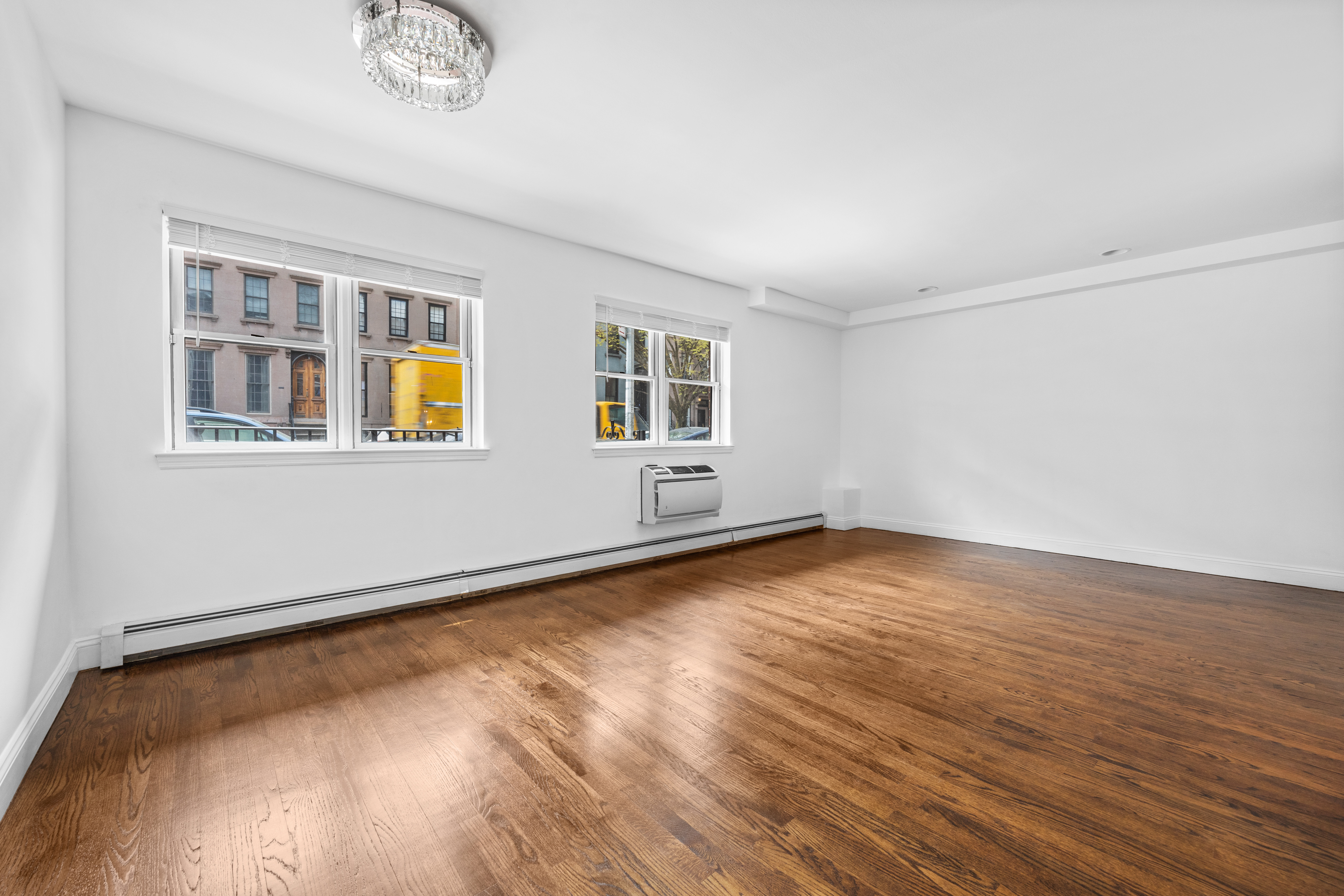 125 Bergen Street, Unit 1A Brooklyn, NY 11201 - Photo 8 of 9 a view of an empty room with wooden floor and a window