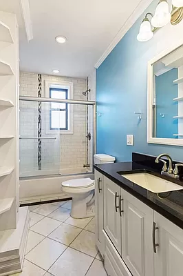 779 Riverside Drive, Unit C41 Manhattan, NY 10032 - Photo 4 of 5 a bathroom with a granite countertop sink a toilet a mirror and shower