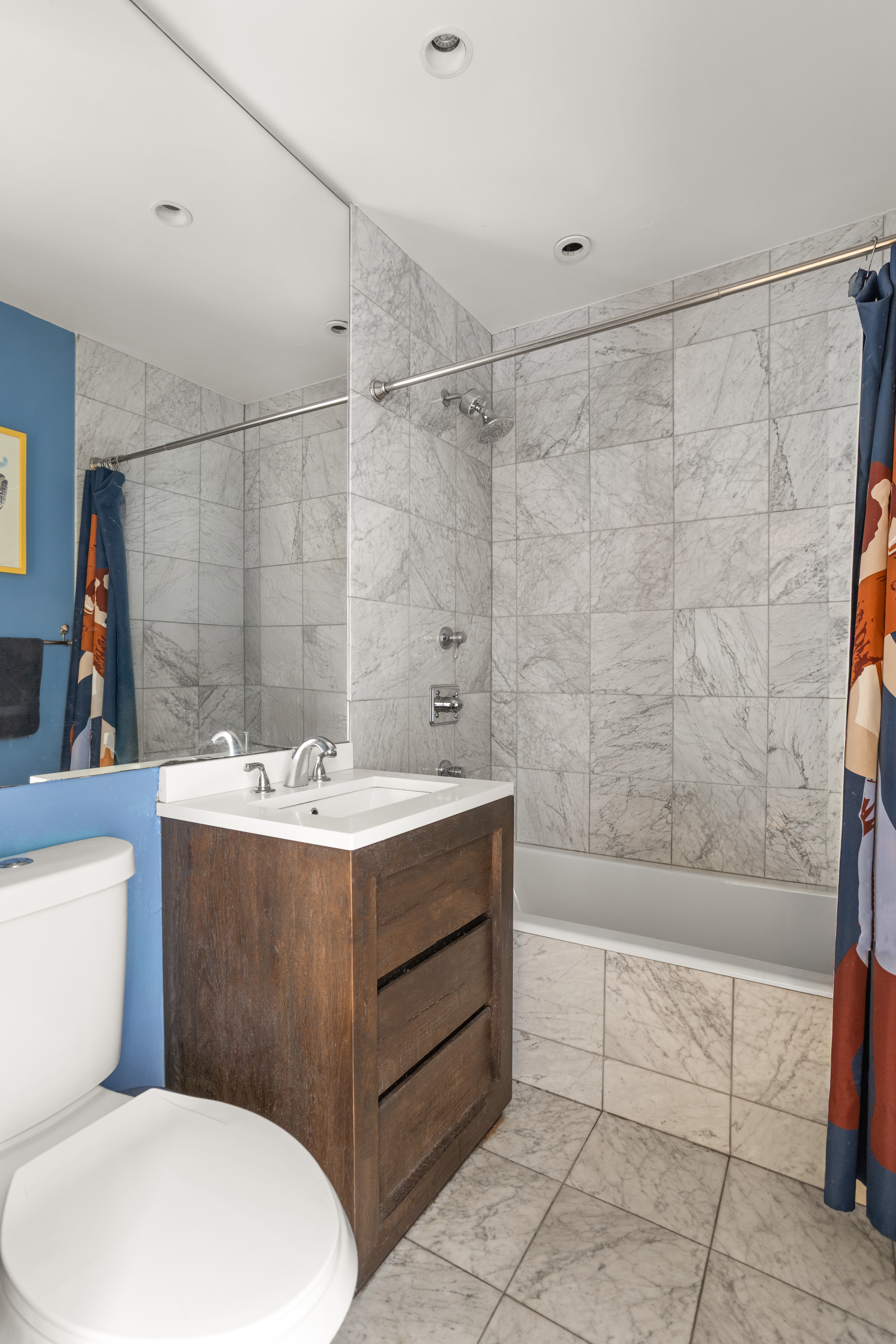 161 East 90th Street, Unit 5C Manhattan, NY 10128 - Photo 11 of 14 a bathroom with a sink mirror vanity and toilet