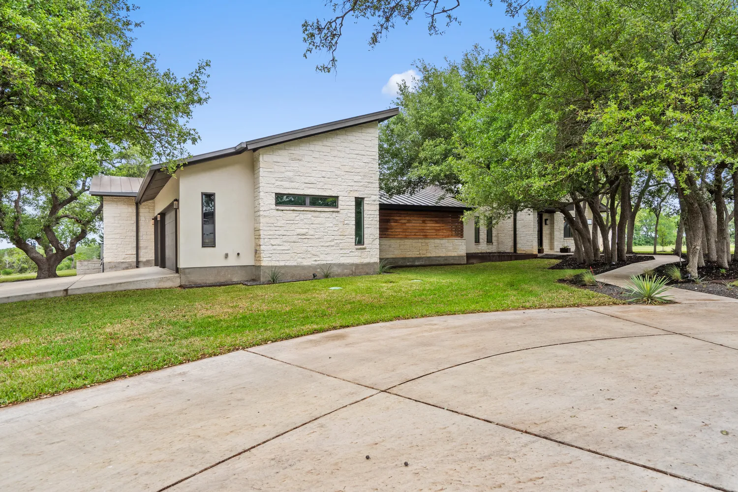 a kitchen with stainless steel appliances kitchen island granite countertop a table chairs in it and wooden floors