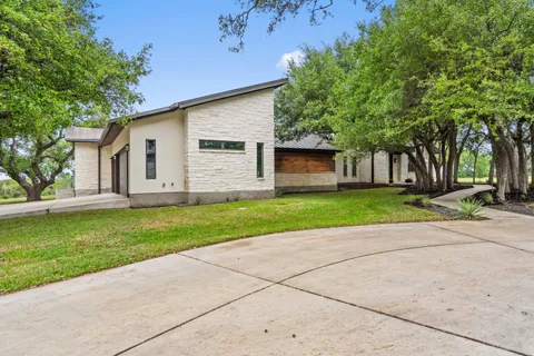 a kitchen with stainless steel appliances kitchen island granite countertop a table chairs in it and wooden floors
