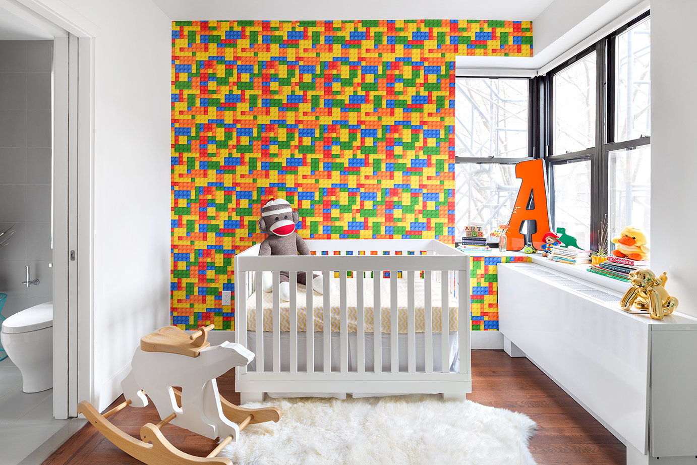 245 West 25th Street, Unit 5H Manhattan, NY 10001 - Photo 4 of 13 a bedroom with a baby crib and a couch