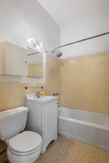 a bathroom with a toilet a sink and bathtub