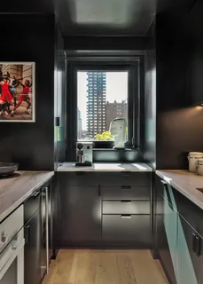 a kitchen with a sink and large window