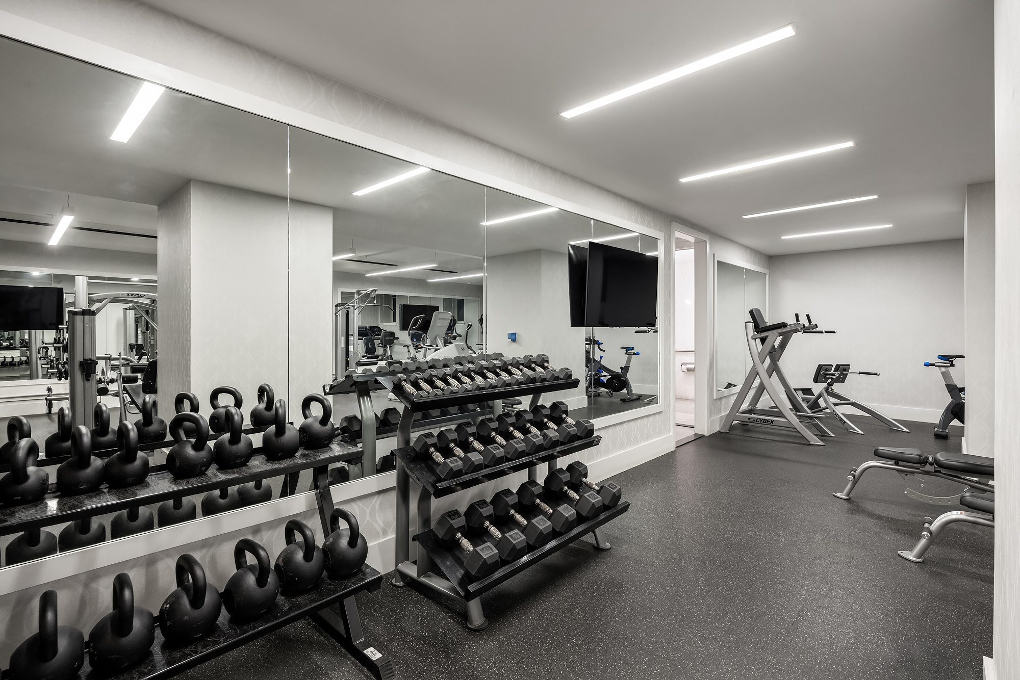 344 West 72nd Street, Unit 1007 Manhattan, NY 10023 - Photo 22 of 23 a room with gym equipment and a large window