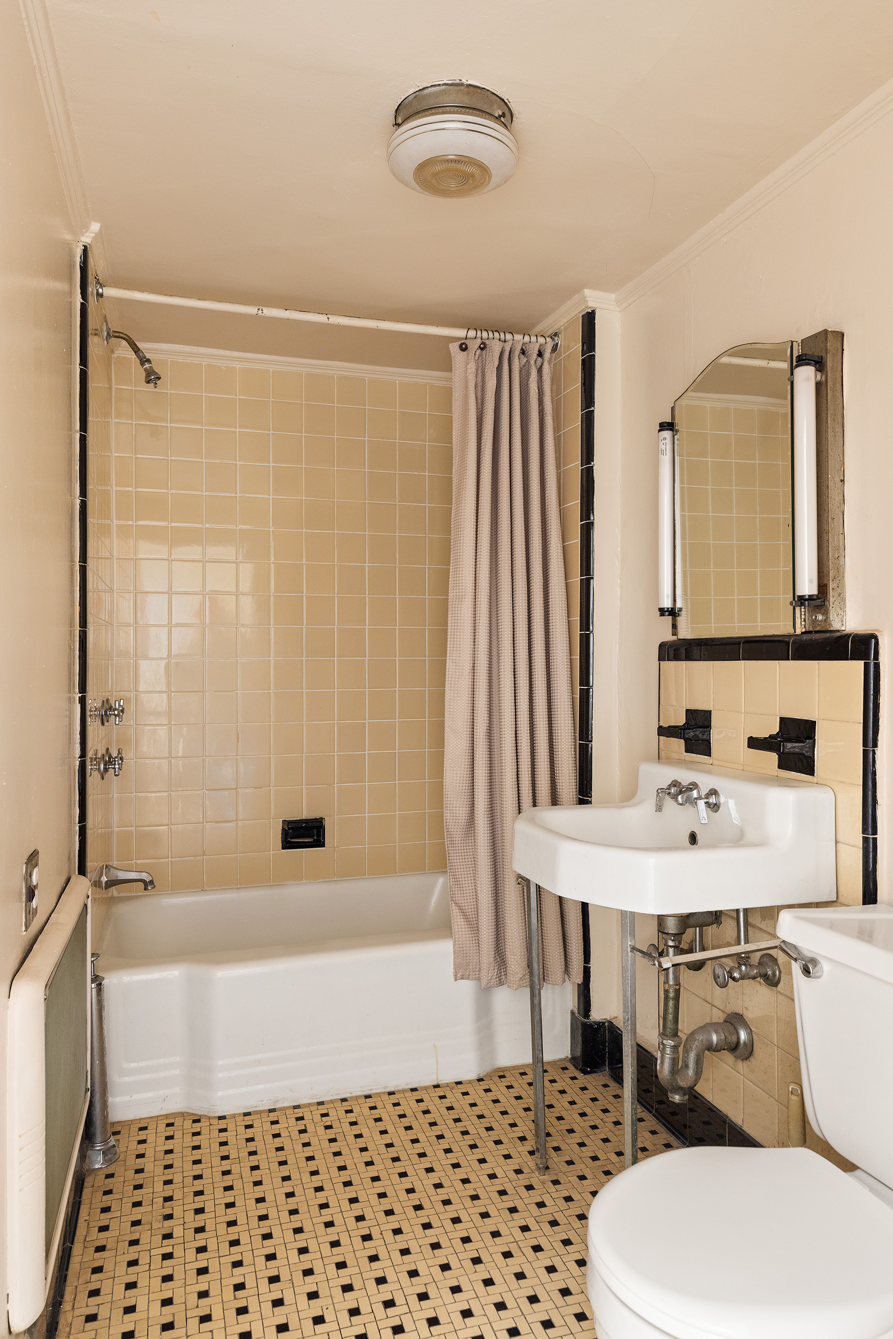 116 Brooklyn Avenue Brooklyn, NY 11216 - Photo 18 of 21 a bathroom with a sink a toilet a mirror and shower