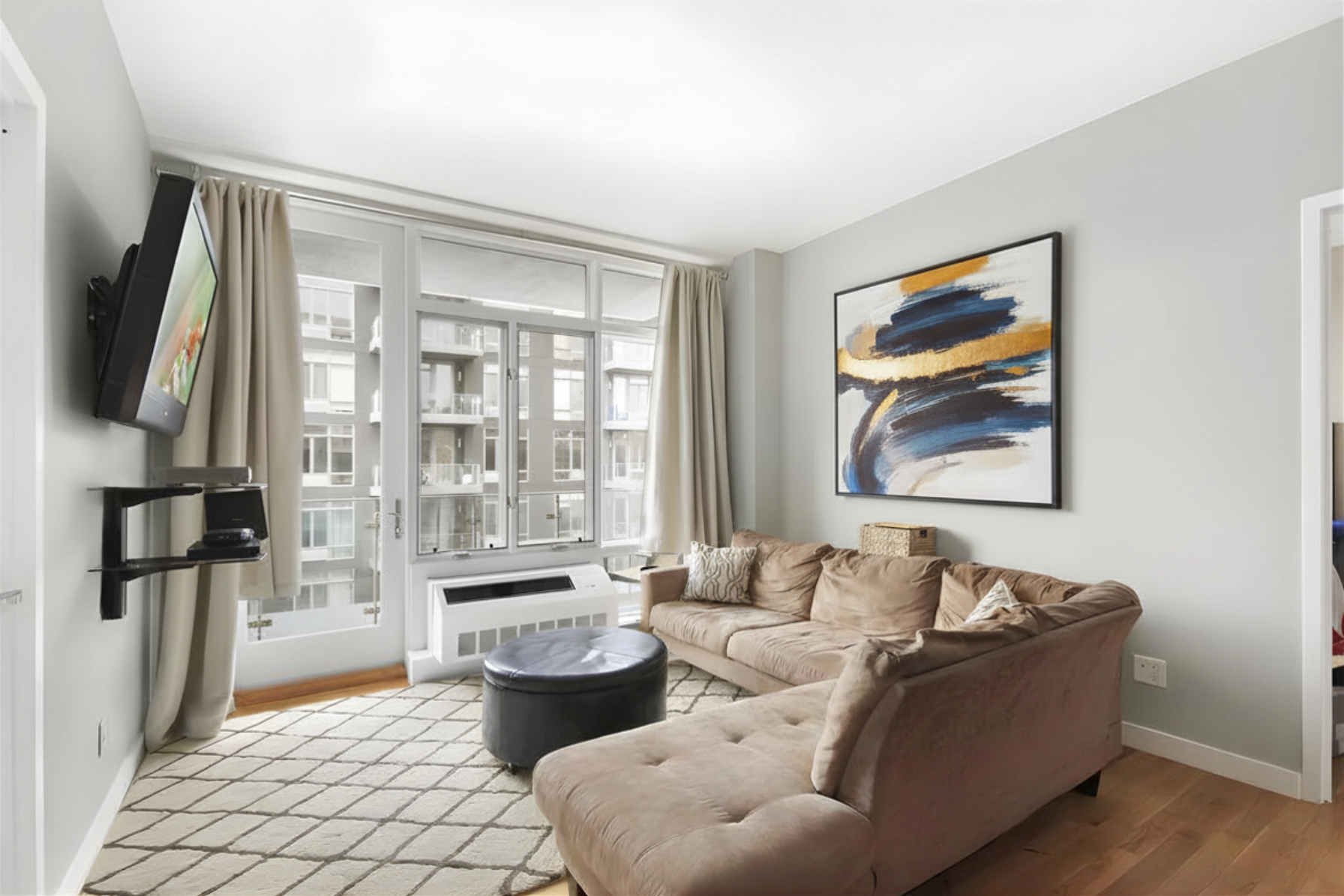 a living room with furniture and a floor to ceiling window