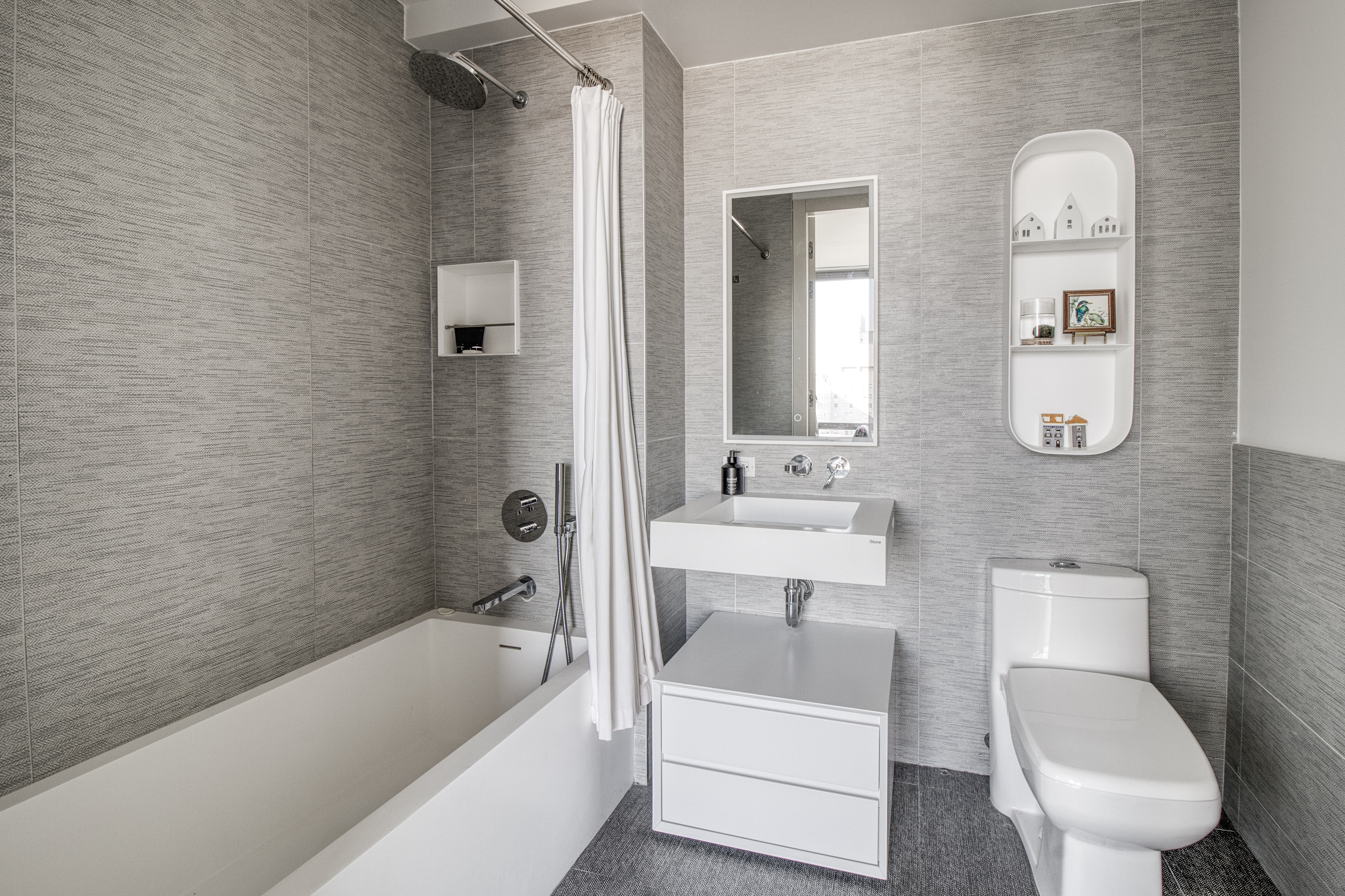 302 East 96th Street, Unit 1103 Manhattan, NY 10128 - Photo 15 of 22 a bathroom with a toilet a sink and bathtub