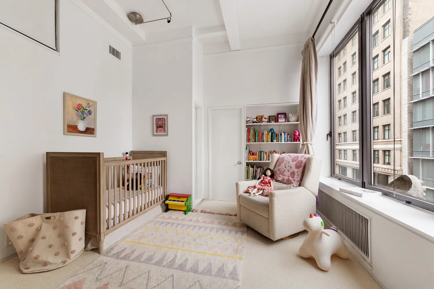 a bedroom with furniture and a large window