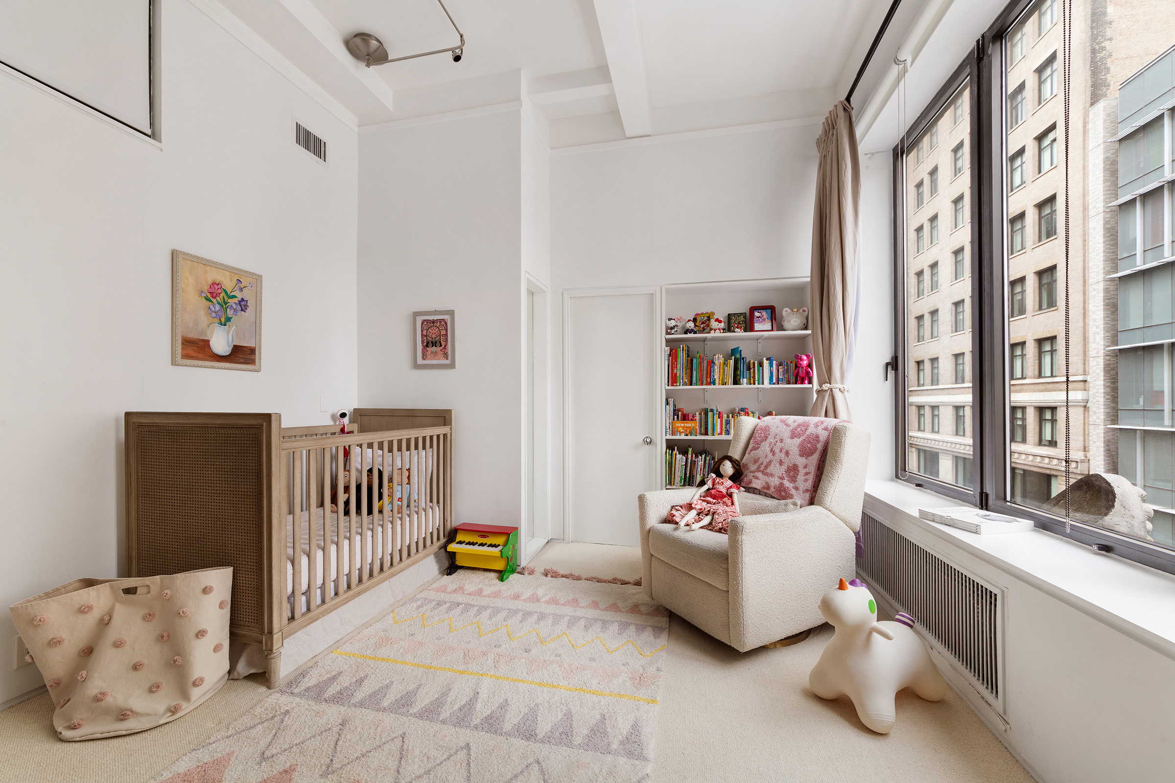 12 East 12th Street, Unit 5N Manhattan, NY 10003 - Photo 6 of 9 a bedroom with furniture and a large window