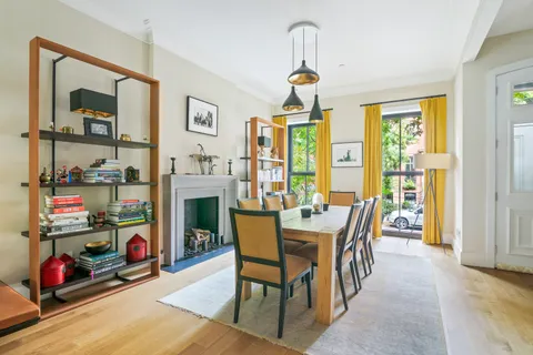 a dining room with furniture and a window