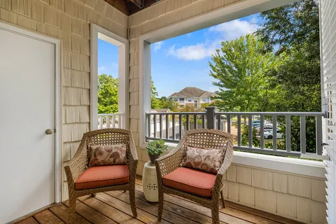 a balcony with furniture and wooden floor