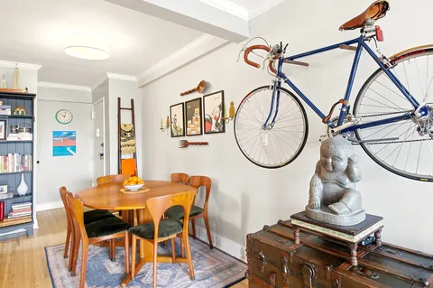 a dining room with furniture and wooden floor