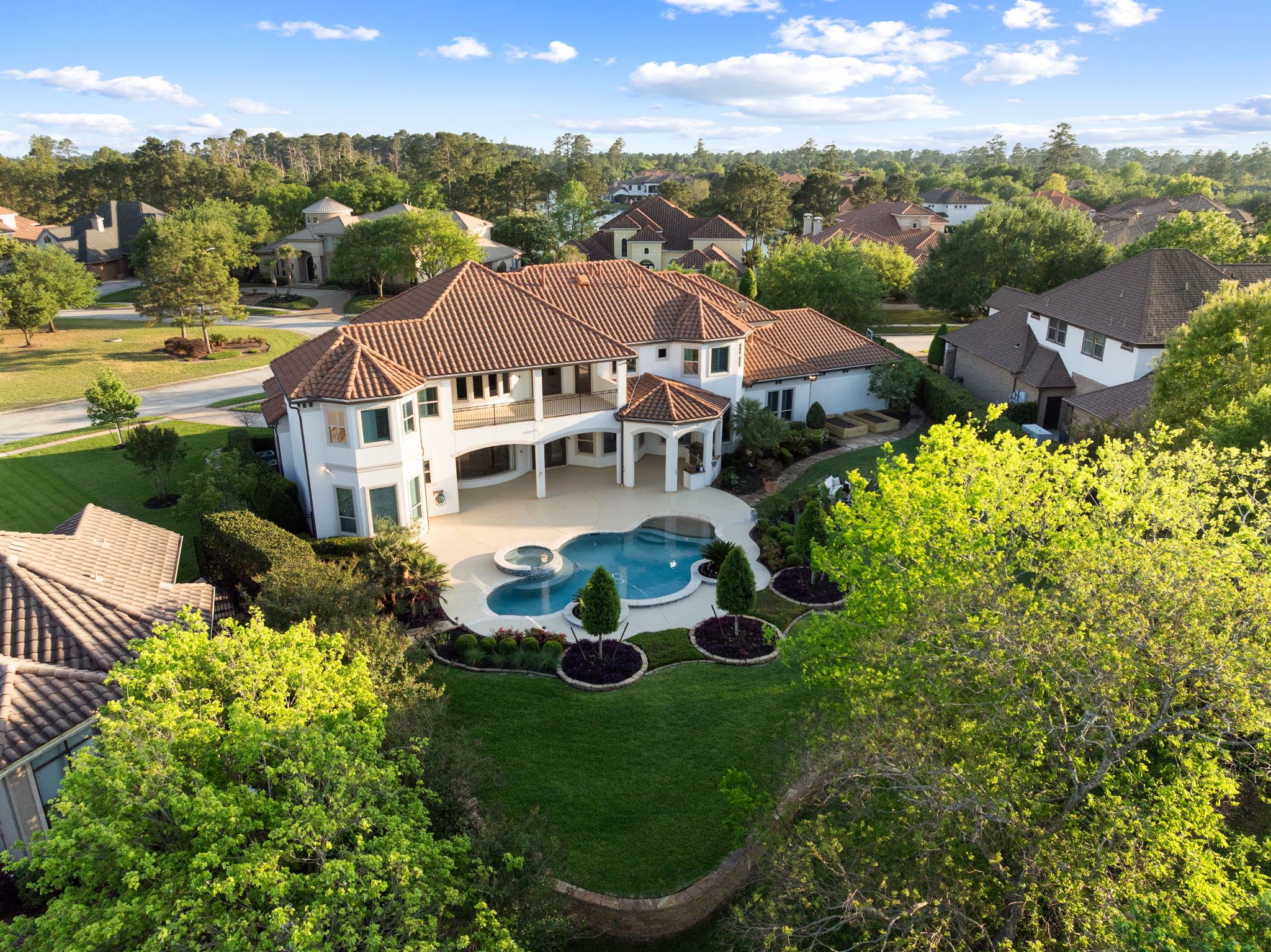 82 Manor Lake Estates Circle Spring, TX 77379 - Photo 5 of 52 a view of a white house with a big yard plants and large trees