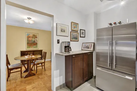 a kitchen with stainless steel appliances granite countertop a sink and a refrigerator