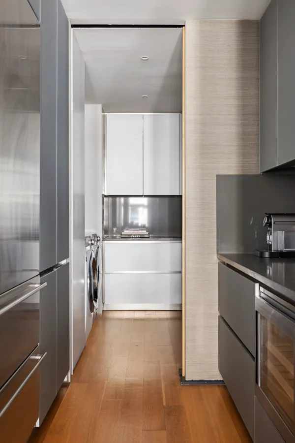 a kitchen with a refrigerator and a sink