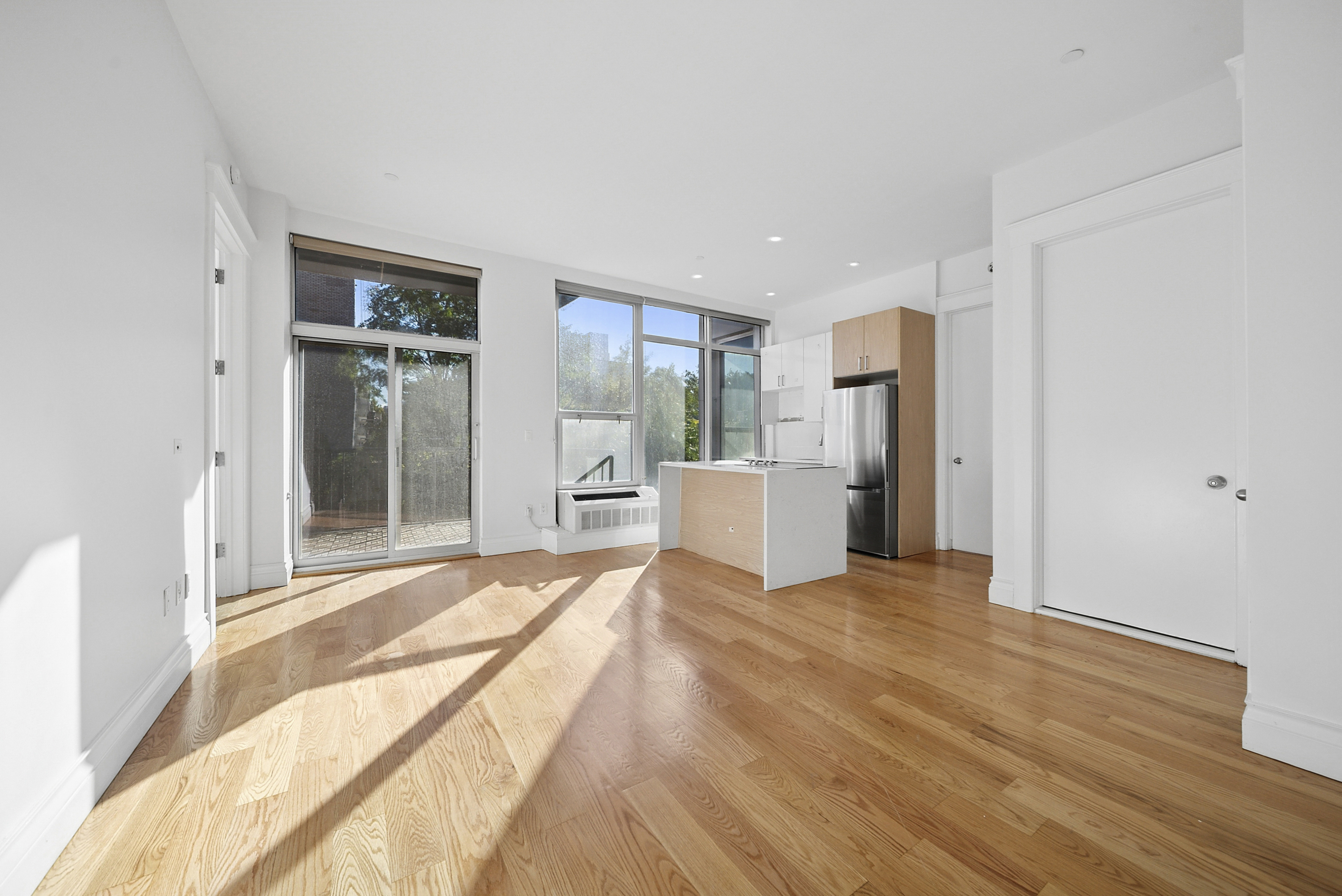 480 Humboldt Street, Unit 3B Brooklyn, NY 11211 - Photo 12 of 19 a view of a kitchen with refrigerator and windows