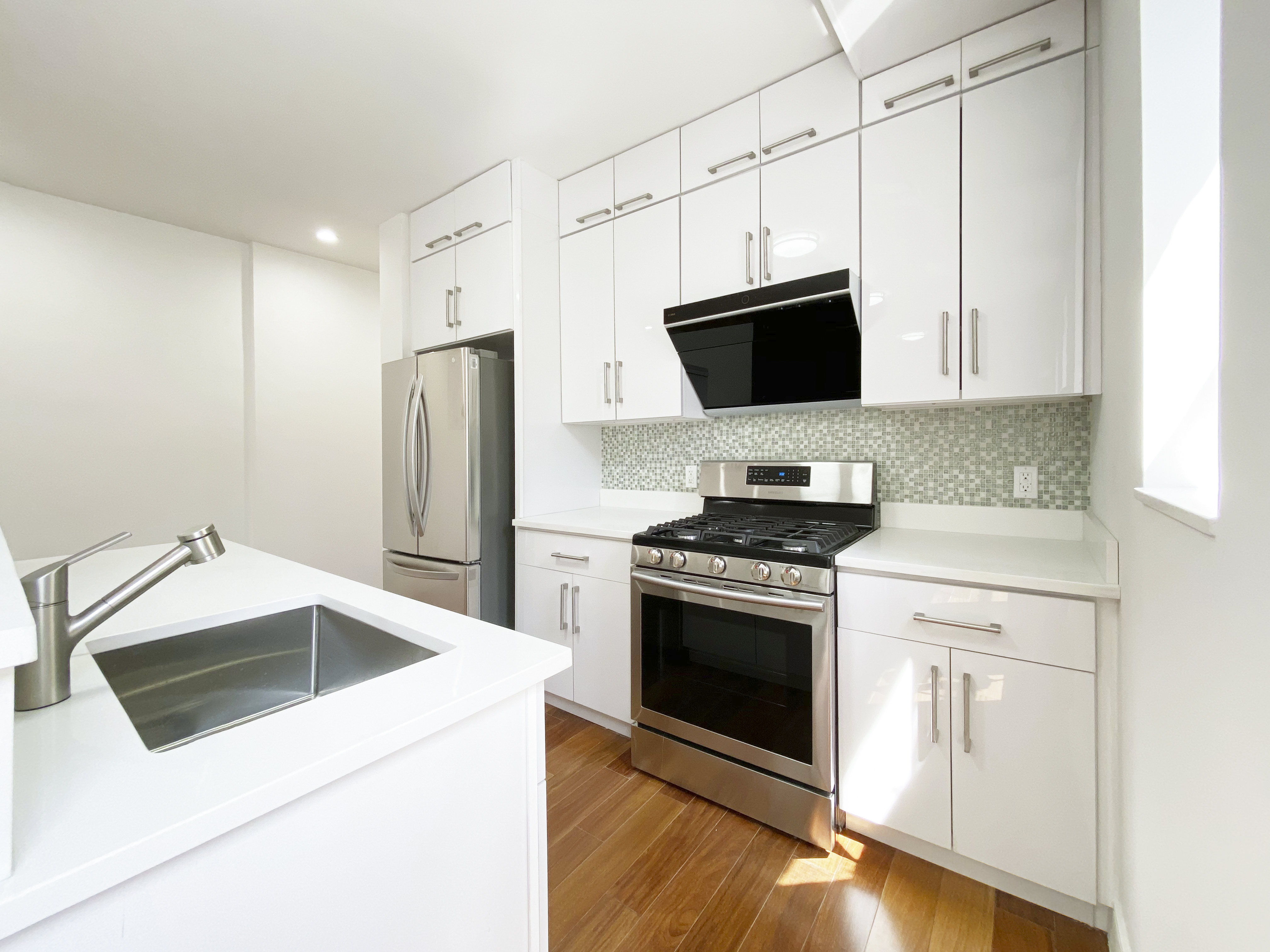 200 West 109th Street, Unit E4 Manhattan, NY 10025 - Photo 3 of 13 a kitchen with stainless steel appliances white cabinets and a stove top oven
