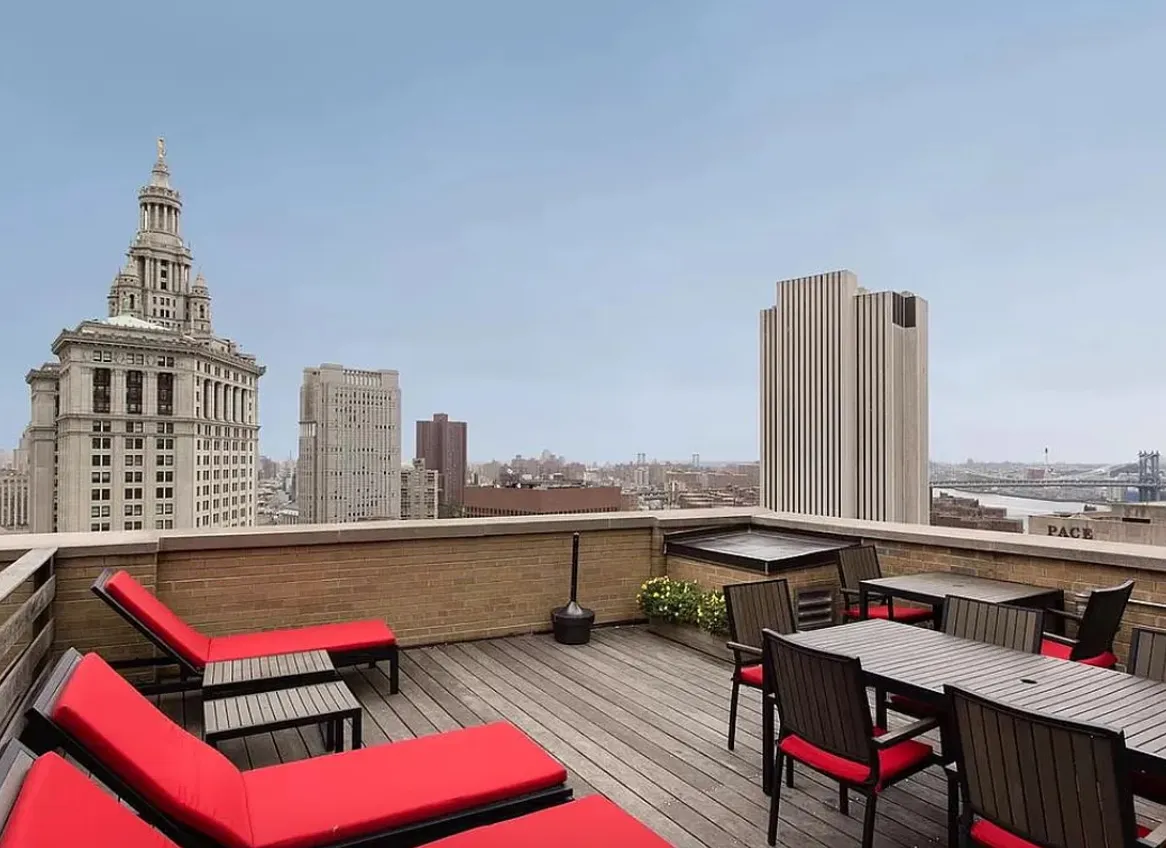 a roof deck with a table and chairs