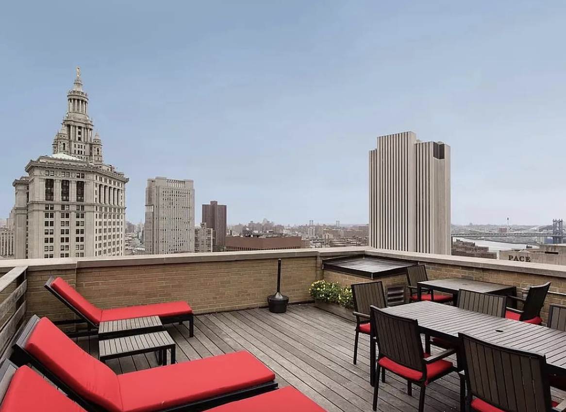 150 Nassau Street, Unit 11B Manhattan, NY 10038 - Photo 14 of 17 a roof deck with a table and chairs