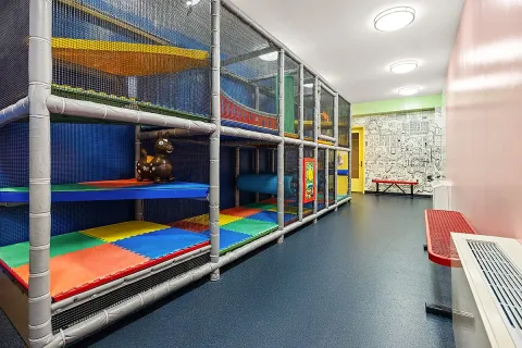 a view of room with windows book shelves