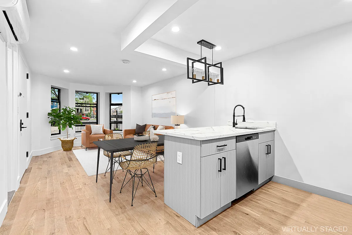 a kitchen with a sink and chairs