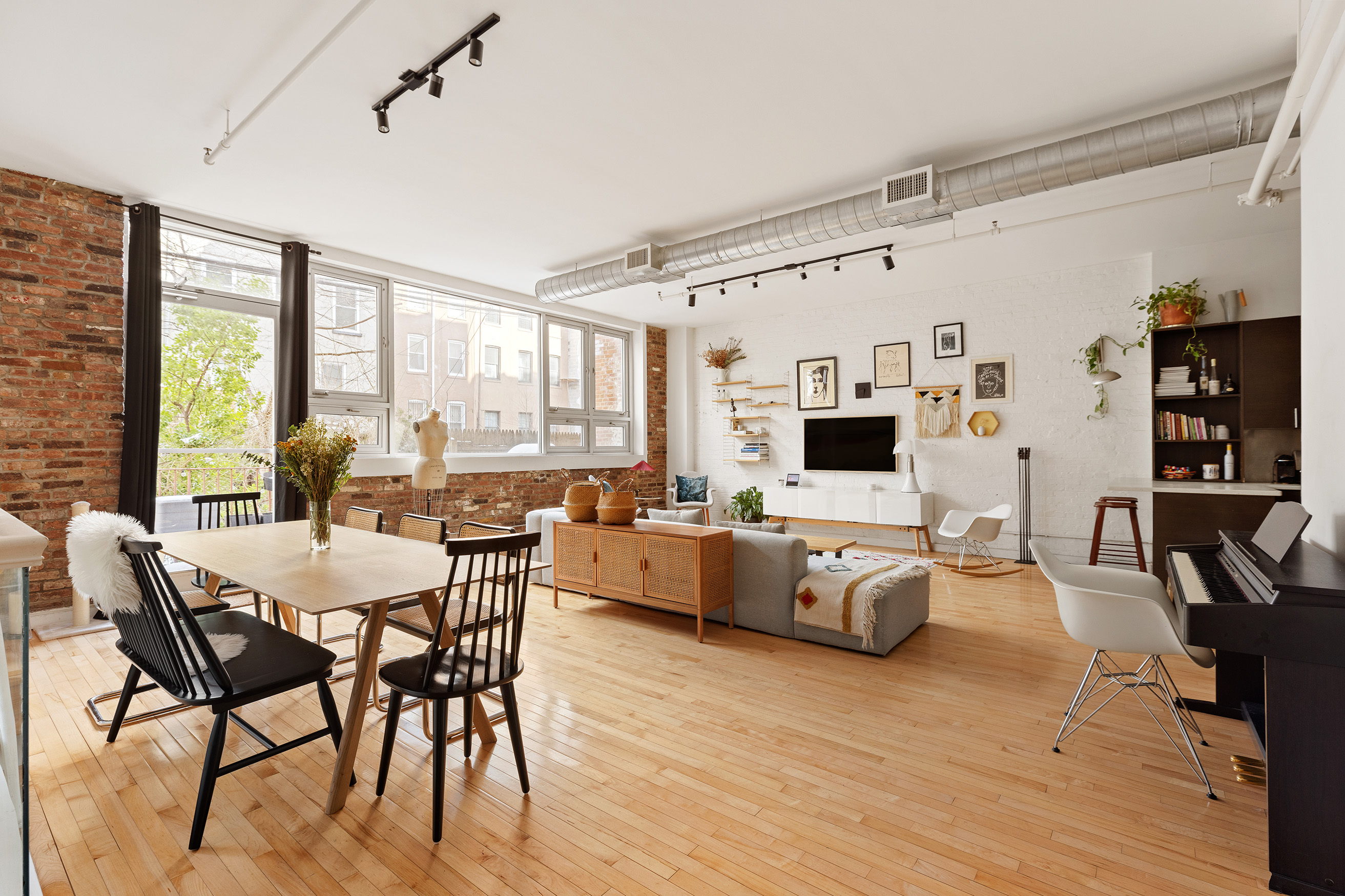 a living room with furniture wooden floor and a flat screen tv