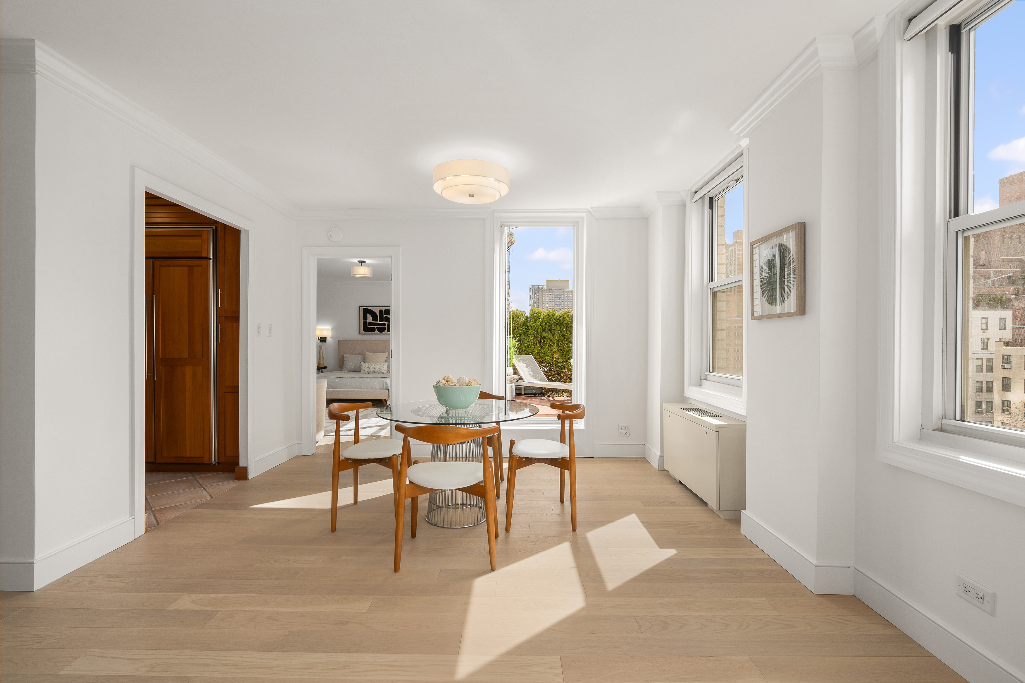 207 East 74th Street, Unit 11E Manhattan, NY 10021 - Photo 4 of 20 a living room with furniture and a window