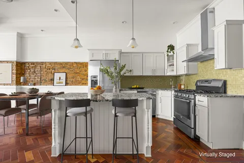 a kitchen with a table chairs stove and cabinets