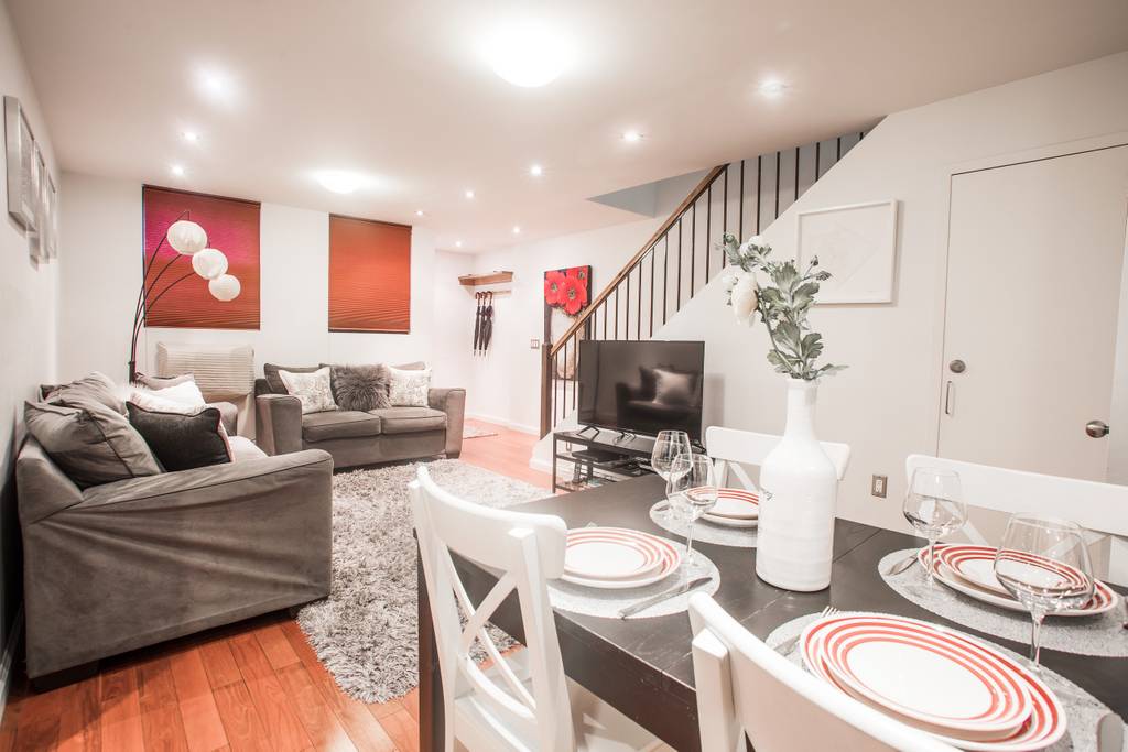 153 Stanton Street, Unit A1 Manhattan, NY 10002 - Photo 10 of 16 a living room with furniture and a flat screen tv