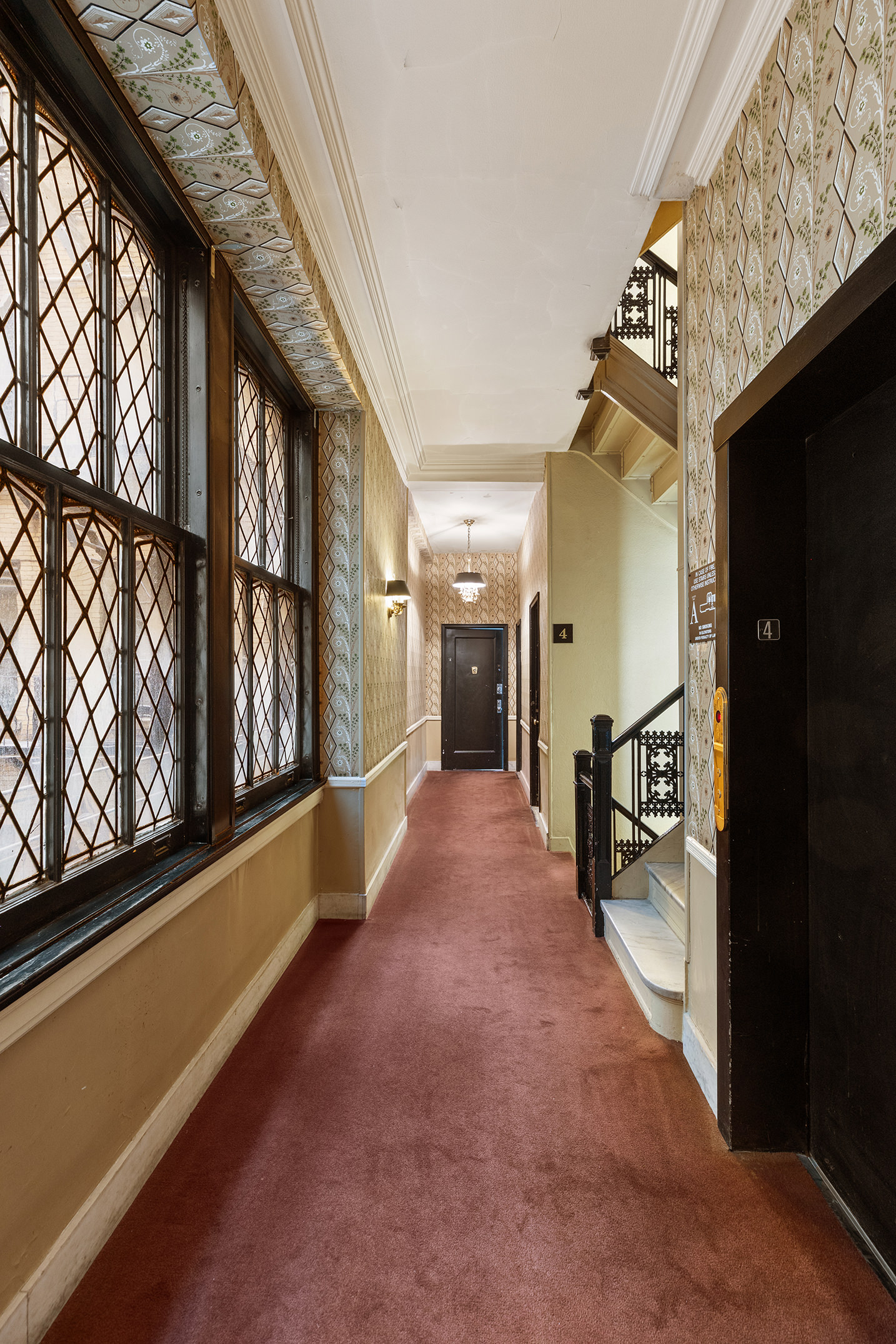 45 East 66th Street, Unit 4NW Manhattan, NY 10065 - Photo 21 of 29 a view of a hallway with wooden floor and staircase