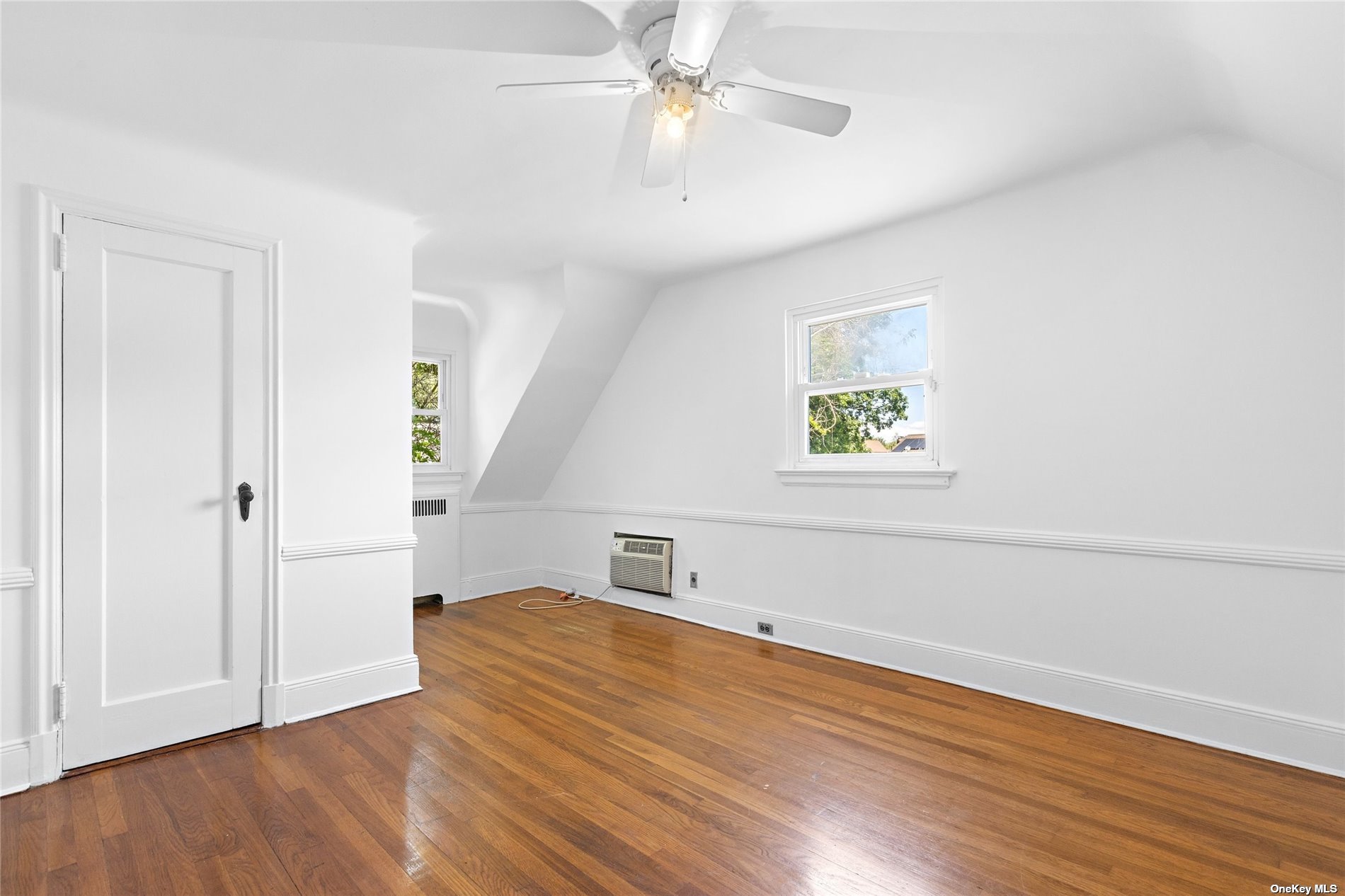 85-23 Edgerton Boulevard Queens, NY 11432 - Photo 19 of 36 wooden floor in an empty room with a window