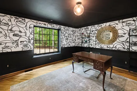 a bedroom with furniture and large windows