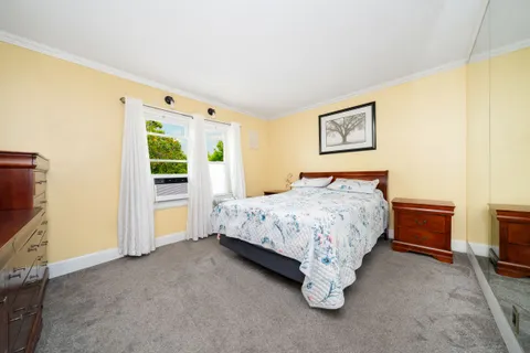 a bed sitting in a room next to a window