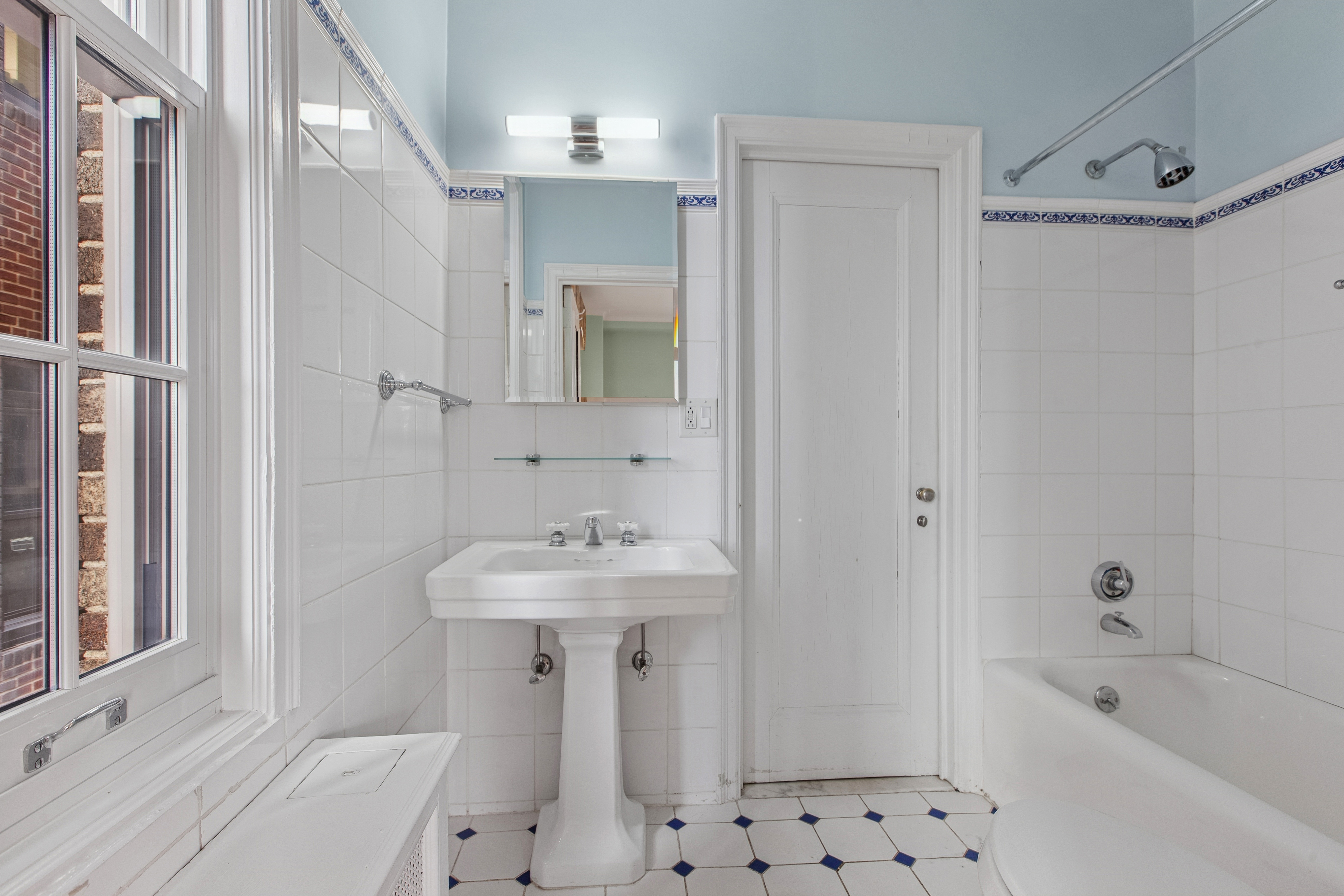 1170 5th Avenue, Unit 6A Manhattan, NY 10029 - Photo 16 of 17 a bathroom with a sink a toilet and shower